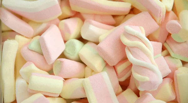 Színes cukros cukorka, különböző édes cukorka háttérrel — Stock Fotó
