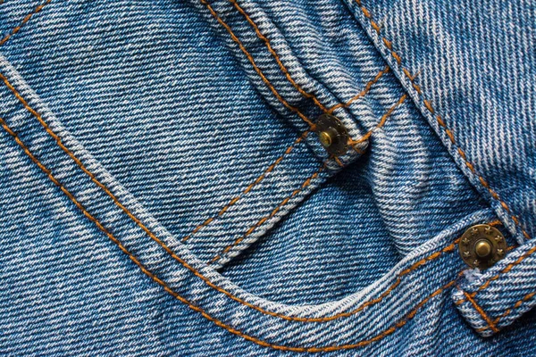 Textura de jeans jeans, tecido de algodão. Bolso e rebite. Têxtil — Fotografia de Stock
