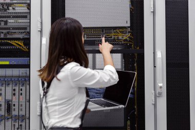 Sunucu odası Server'da analiz edilirken dizüstü bilgisayar kullanan teknisyen apecialist kadın