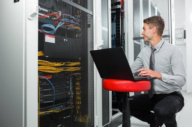  Genç adam Server supercomputer içinde veri merkezi ile çalışırken kabine telleri bağlarken
