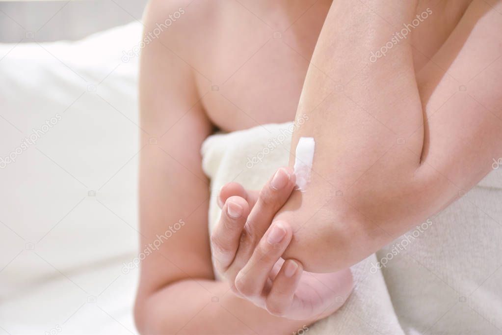 Woman applying elbow cream,lotion , Hygiene skin body care conce