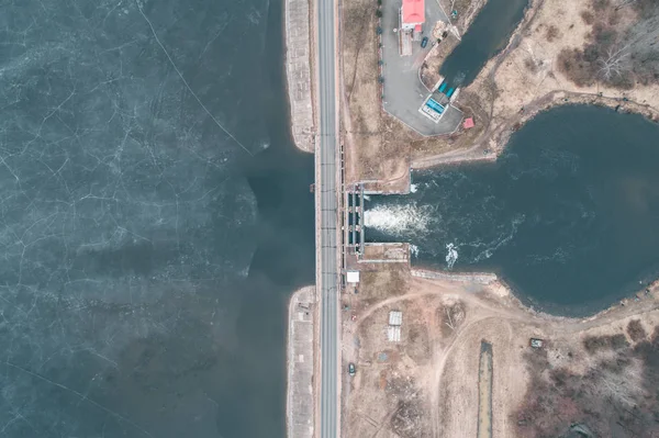 water dam on the reservoir during the winter-spring period, view from above