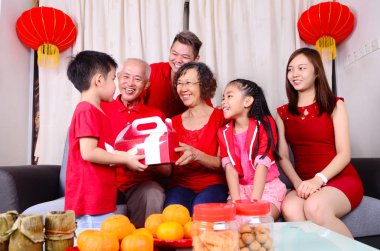 Asian three generations family celebrate chinese new year clipart