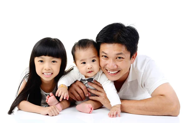 アジアの父と彼のかわいい娘と息子は白い背景に隔離された床の上に横たわっています — ストック写真