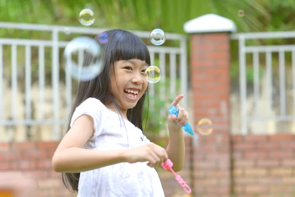 Lovely Little Asian Girl Blowing Soap Bubbles Outdoor Portrait — Stock Photo, Image