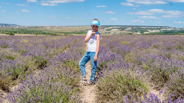 Sorridente signora in un campo di lavanda con un bel sorriso in occhiali da sole con la pelle bianca stand — Foto Stock