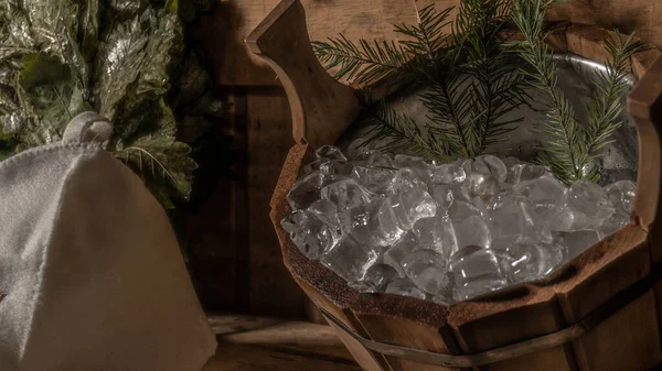 In the bath ice and cap, wooden sauna, a bucket of cold in the bath room — Stock Photo, Image