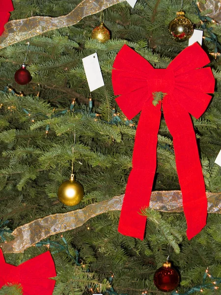 Red Bow, Christmas Balls and Wish Cards on Pine Tree