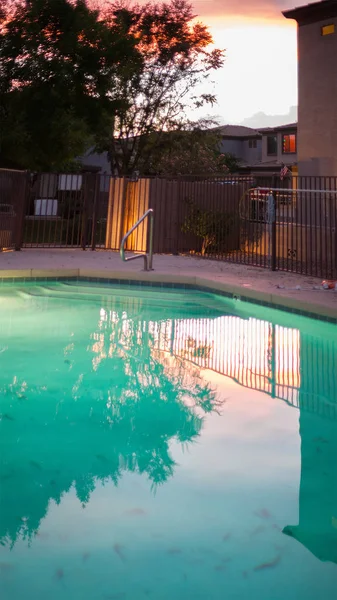 Swimming pool in Arizona backyard at late evening during monsoon season in Phoenix, Arizona