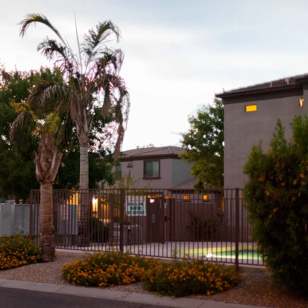 Gated swimming pool in Arizona backyard at late evening during monsoon season in Phoenix, Arizon