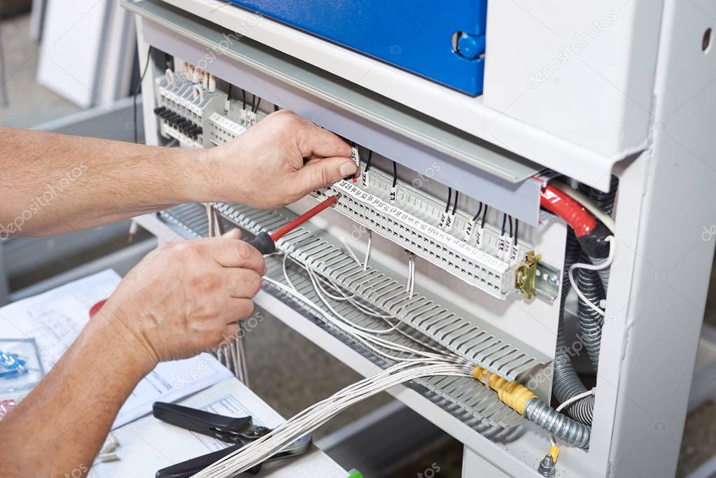 The electrician performs the installation and configuration of high-voltage equipment.