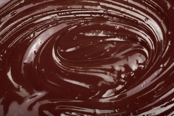 Remolino de chocolate derretido como primer plano de fondo —  Fotos de Stock