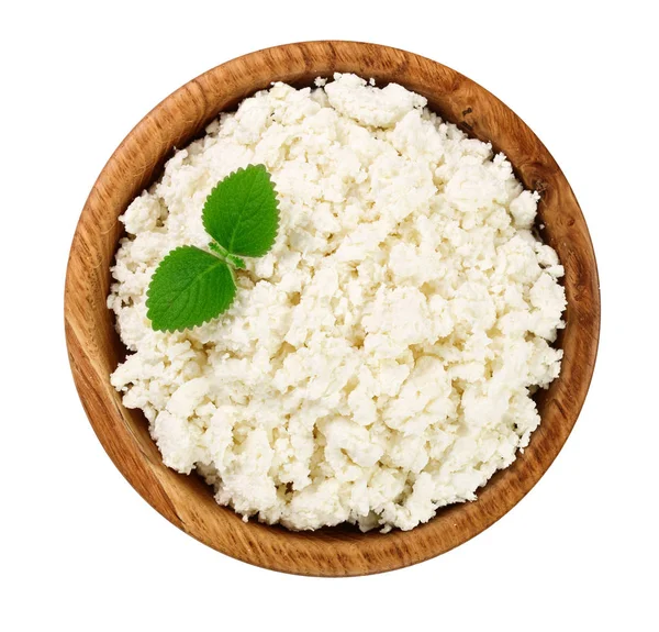 Cottage cheese in a wooden bowl isolated on a white background. Top view. Flat lay — Stock Photo, Image
