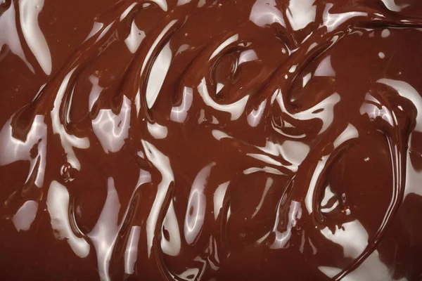 Remolino de chocolate derretido como primer plano de fondo — Foto de Stock