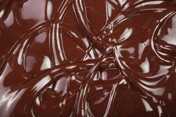 Melted chocolate swirl as a background closeup — Stock Photo, Image