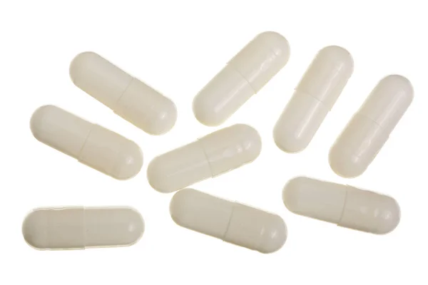 Cápsula de píldora blanca aislada sobre fondo blanco. Vista superior. Puesta plana — Foto de Stock