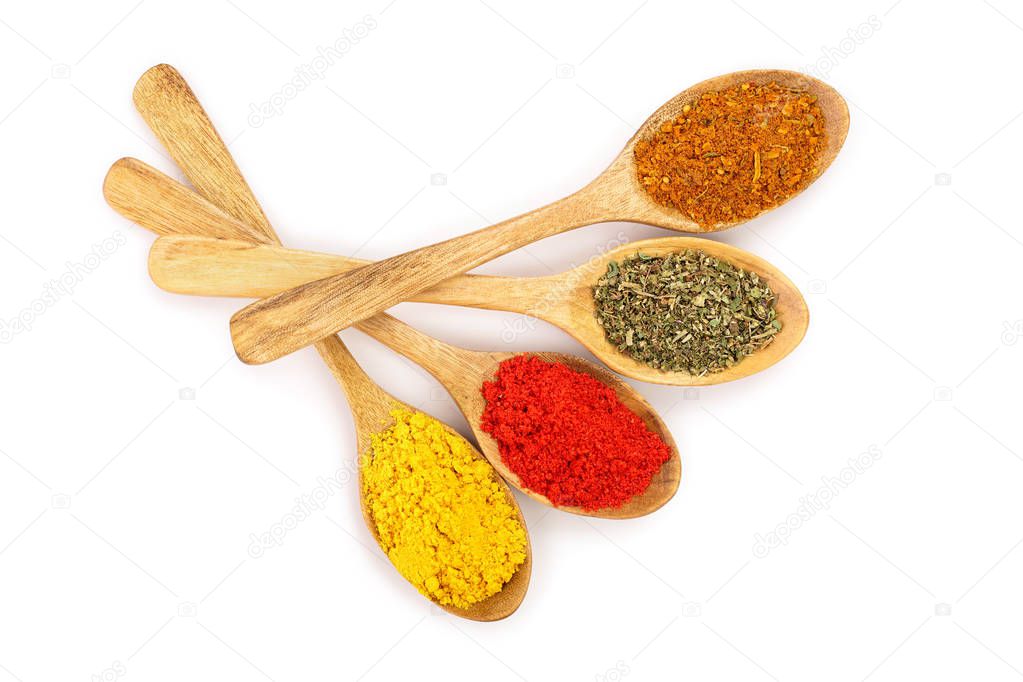 mix of spices in wooden spoon isolated on a white background. Top view. Flat lay. Set or collection