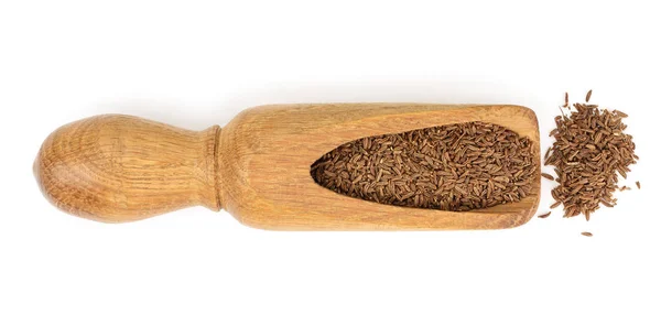 Cumin or caraway seeds in wooden spoon isolated on white background. Top view — Stock Photo, Image