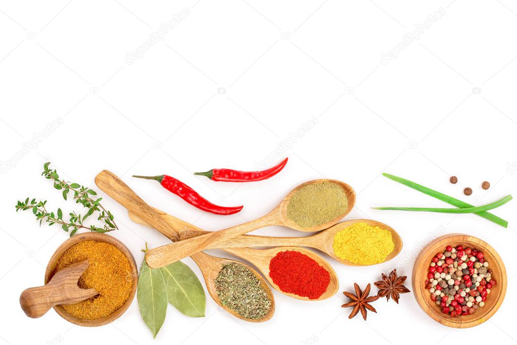 mix of spices in wooden spoon isolated on a white background with copy space for your text. Top view. Flat lay. Set or collection