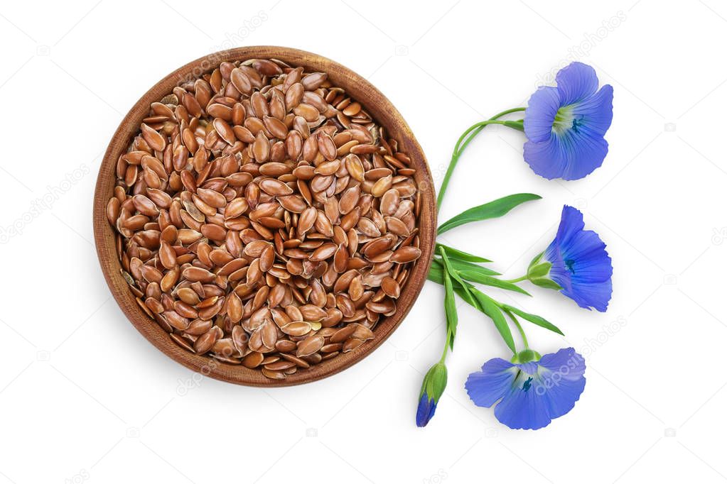 flax seeds in wooden bowl with flower isolated on white background