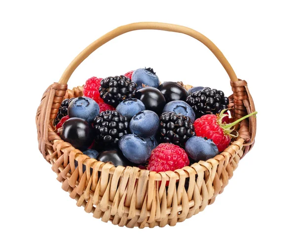 Mix of blackberry blueberry raspberry black currant in wicker basket isolated on white background. — Stock Photo, Image