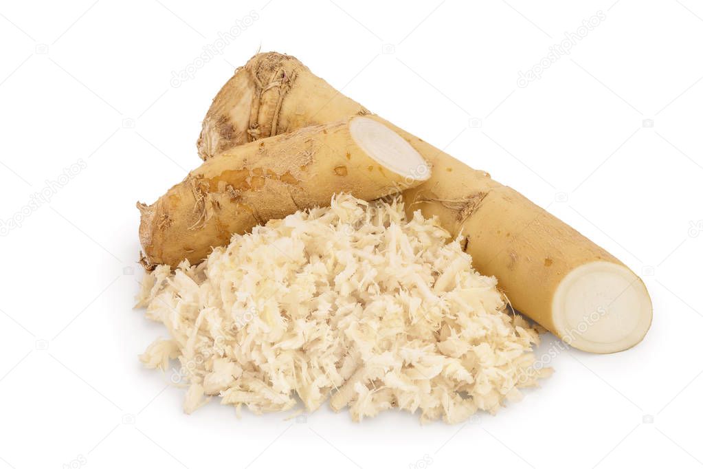 Horseradish root with slices grated pile isolated on white background