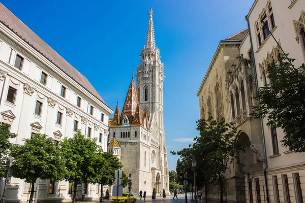 white gothic catholic church tower in summer time european old city small ctreet