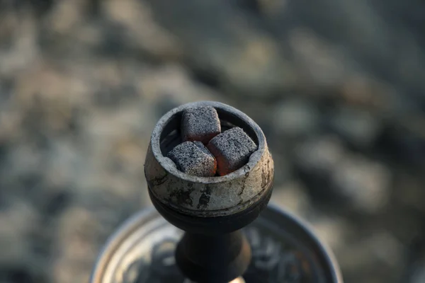 hot hookah coals with orange illumination in smoking on unfocused bokeh background with empty space for copy or text, relaxation concept picture