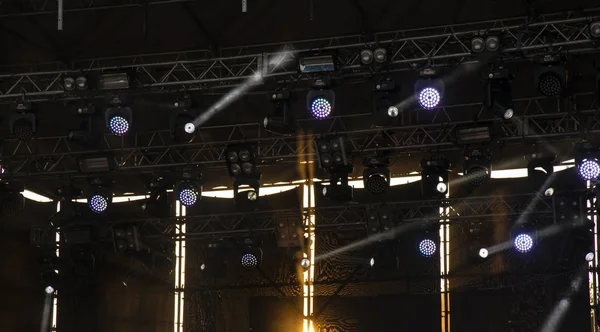 music stage construction spot light and projector light rays illumination in darkness