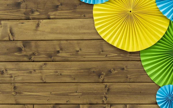 beautiful simple background photo zone of deck wooden wall with empty copy space and colorful yellow green and blue hand made paper decoration in corner of picture