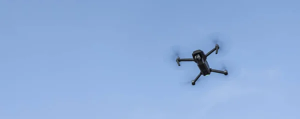 concept picture of modern technologies drone object for aerial photography on empty blue sky background with copy space for text