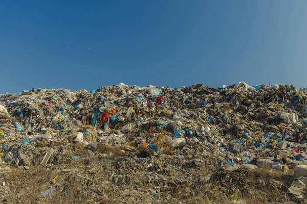 huge hill of garbage and rubbish on suburban dump awful view background concept photography on climate changing and global pollution theme with empty copy space for your text or inscription