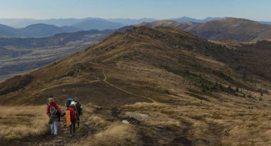 Yaşam tarzı seyahat konsepti fotoğrafçılığı. İnsanlar muhteşem bir dağ sırtında yürüyüş yapıyor. Dramatik sonbahar manzarası. 