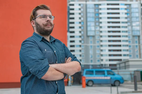 Caucasian white man portrait business manager in rustic wear cloth style posing looking side ways on architecture building construction industrial area background space