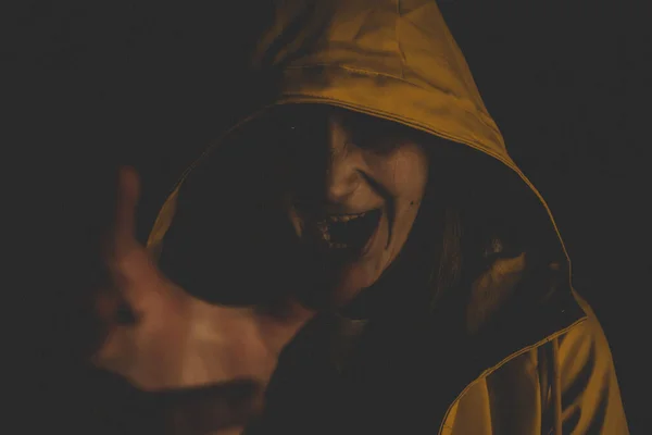 soft focus noise pollution girl portrait scare expression Halloween concept face photography in yellow rain coat in darkness lighting