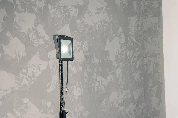 studio lamp lighting equipment indoor interior space gray textured wall background view copy space