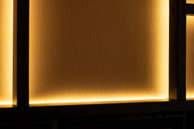 iç tasarım elemanı duvar arkaplan dokusu raf çerçeve çalışması ile sıcak sarı aydınlatma lamba kapalı nesne resim kopyalama alanı burada metin için