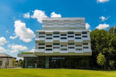 Mimari ofis binasının geleceğe dönük yeşil şehir manzarası bahçe parkı ağaçları ve açık yaz günü yeşillikleriyle çevrili kentsel nesneler.