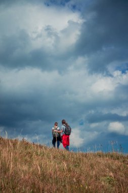 Highland Dramatik Dağ Gökyüzü Dikey Resim Duvar Kağıdı Poster Fotoğrafçılığı. Yürüyüş yapan çiftle birlikte metnin için boş fotokopi alanı olan aktif yaşam tarzı konseptine geri dönüyoruz.