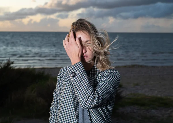 female at the beach with wind in hair