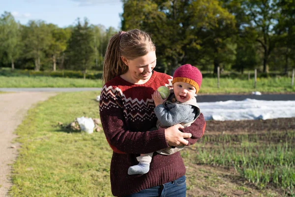 farmer and her child at ecological garden