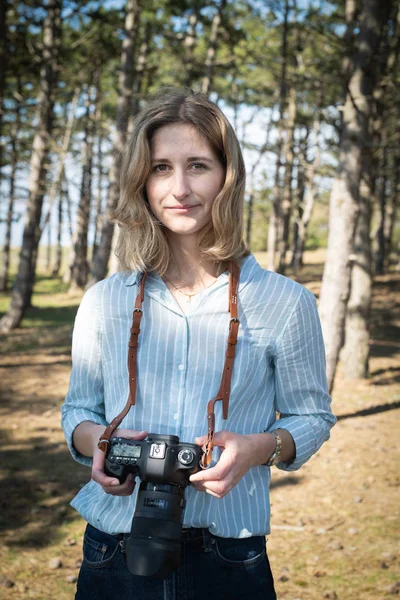 Caucasian woman holding a camera