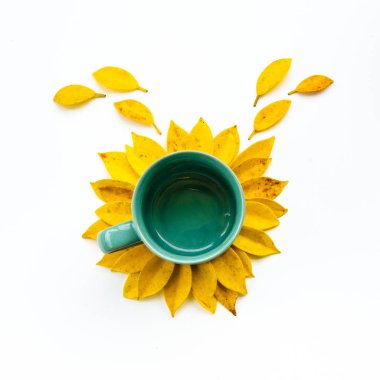 Empty coffee cup with creative arrangement yellow leaf.sunflower made by yellow leaves and coffee cup.flat lay. clipart