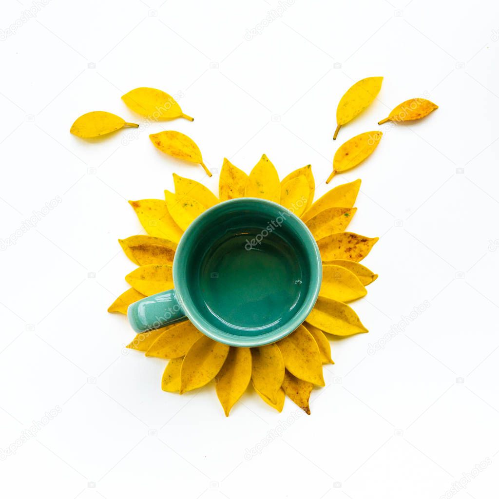 Empty coffee cup with creative arrangement yellow leaf.sunflower made by yellow leaves and coffee cup.flat lay.