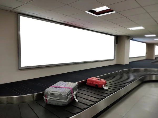 Blank poster banner over luggage belt display.White billboard for promotion announcement and business advertising information mock up.