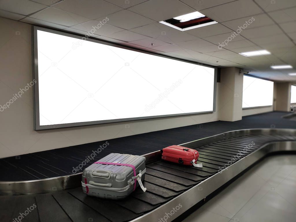 Blank poster banner over luggage belt display.White billboard for promotion announcement and business advertising information mock up.