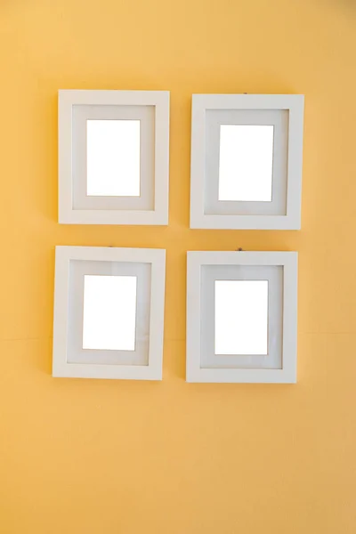 Blank photo frame on yellow wall template.Photo frame decorative mock up.