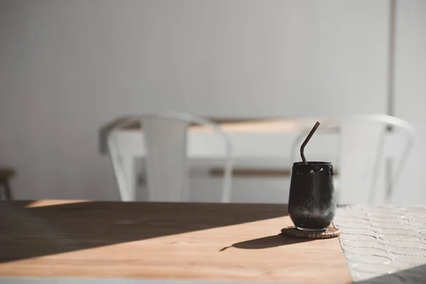 Minuman hitam yang terbuat dari arang dan susu di meja kayu gaya vintage — Stok Foto