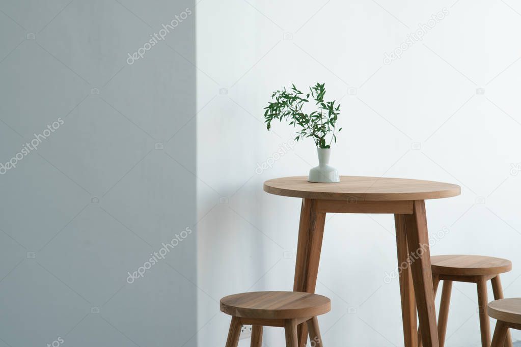 Green plant leaves for interior decoration in a vase and placed on the table.