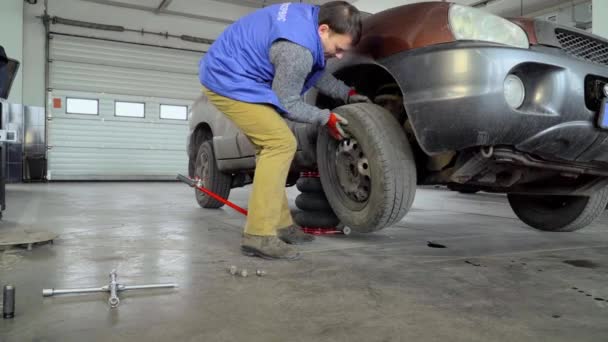 Der Arbeiter Entfernt Das Rad Aus Dem Auto — Stockvideo